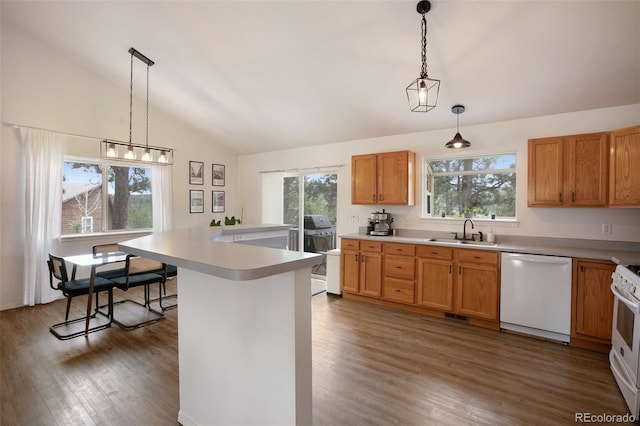 121 Aspen Dr, Woodland Park, CO 80863 - kitchen with white appliances, a sink, vaulted ceiling, dark wood-type flooring, and light countertops