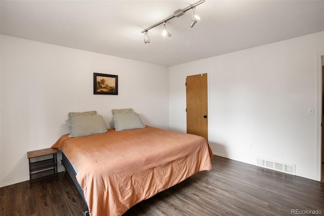 121 Aspen Dr, Woodland Park, CO 80863 - bedroom featuring wood finished floors, rail lighting, and baseboards