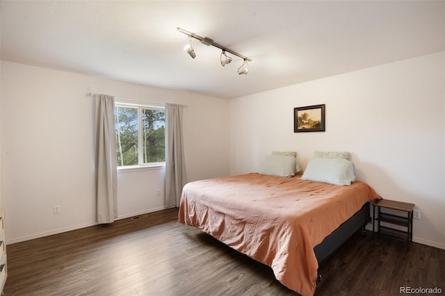 121 Aspen Dr, Woodland Park, CO 80863 - bedroom with baseboards, wood finished floors, and track lighting