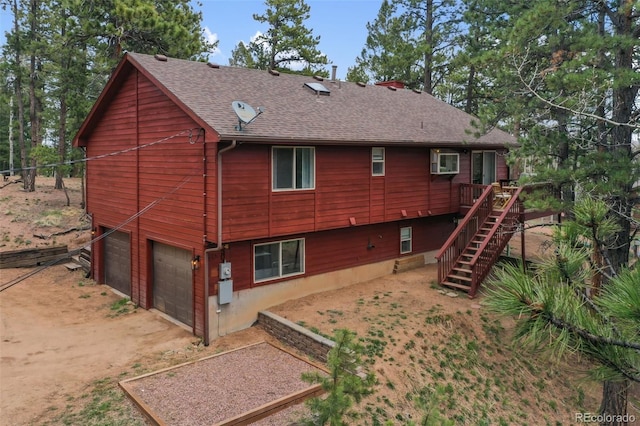121 Aspen Dr, Woodland Park, CO 80863 - back of house featuring roof with shingles, stairs, a deck, and an attached garage