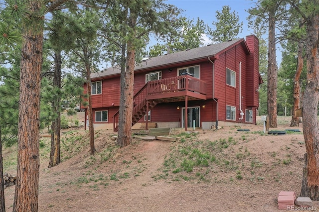 121 Aspen Dr, Woodland Park, CO 80863 - back of property with a wooden deck, a chimney, and stairs