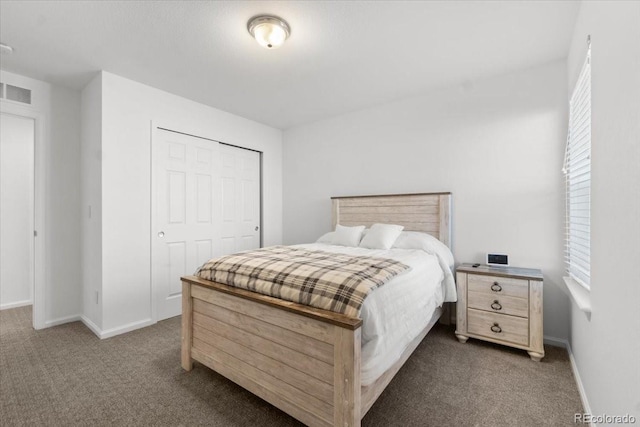 bedroom featuring dark colored carpet and a closet