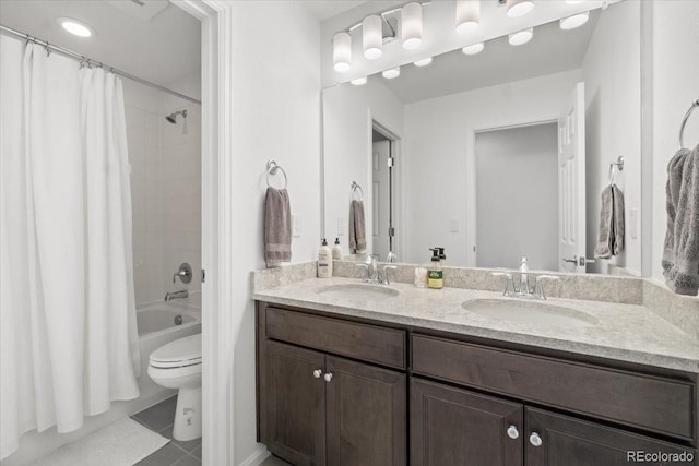 full bathroom featuring vanity, shower / bathtub combination with curtain, tile patterned floors, and toilet