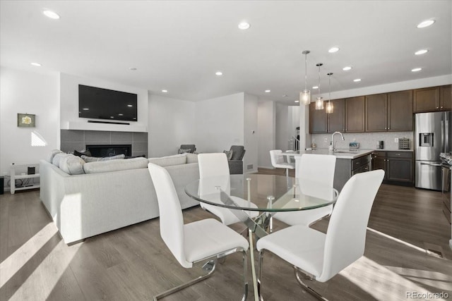 dining area featuring a fireplace and dark hardwood / wood-style flooring