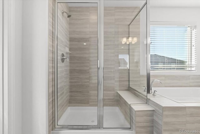 bathroom with separate shower and tub