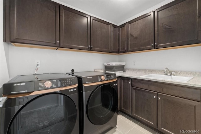 clothes washing area featuring cabinets, light tile patterned flooring, sink, and independent washer and dryer