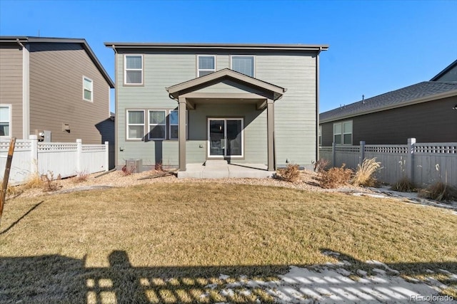 back of property with a patio area, a lawn, and fence