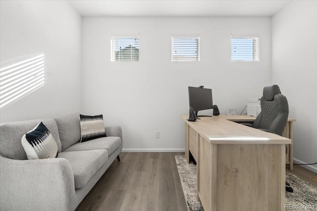 home office featuring baseboards, plenty of natural light, and wood finished floors