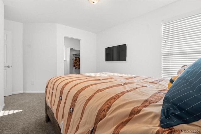 carpeted bedroom featuring baseboards