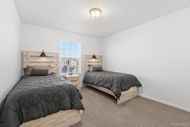 bedroom featuring light colored carpet and baseboards