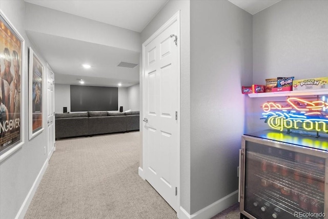 hallway with recessed lighting, carpet flooring, baseboards, and visible vents