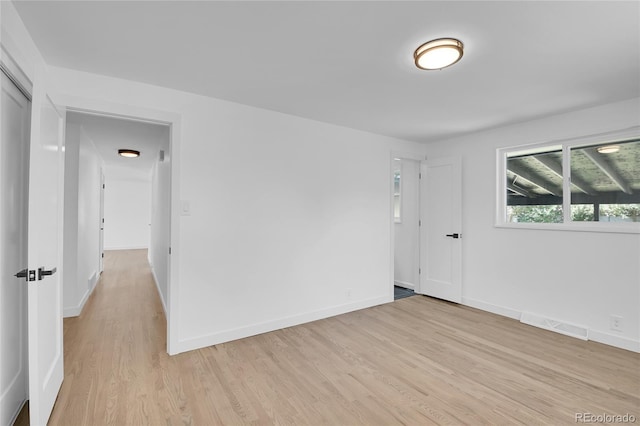 spare room with light hardwood / wood-style floors