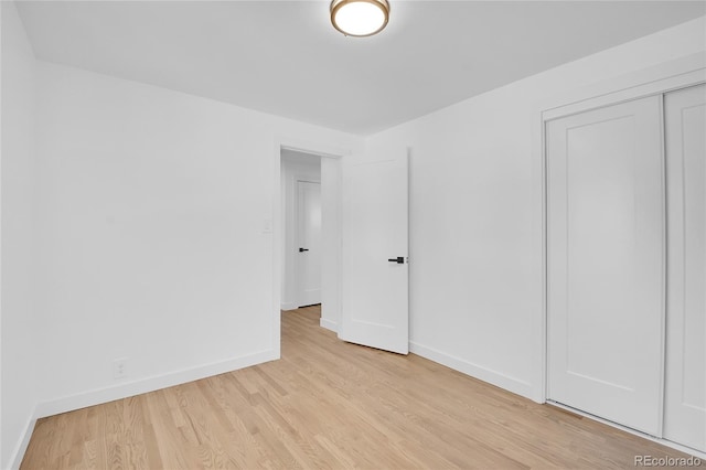 unfurnished bedroom featuring a closet and light hardwood / wood-style flooring