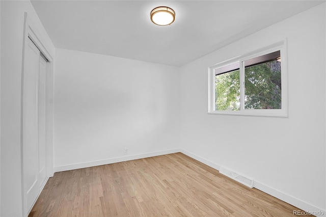 spare room with light hardwood / wood-style flooring