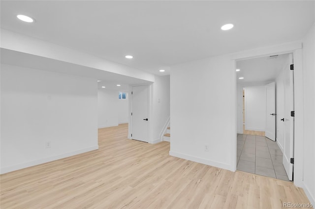 basement with light hardwood / wood-style floors