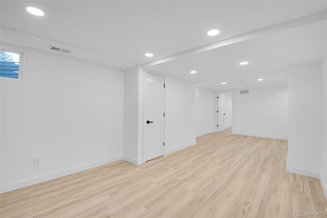 basement with light hardwood / wood-style floors