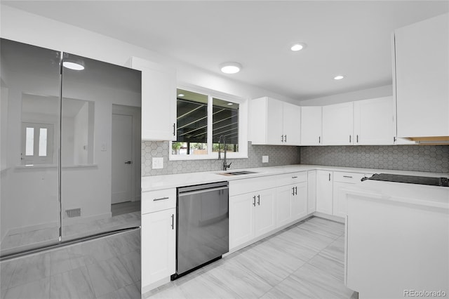 kitchen with black electric stovetop, stainless steel dishwasher, decorative backsplash, sink, and white cabinetry