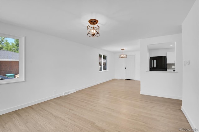 unfurnished living room featuring light hardwood / wood-style floors