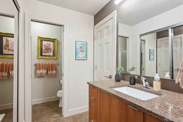 8170 E Phillips Cir, Centennial, CO 80112 - bathroom with vanity, baseboards, toilet, and a shower with shower door