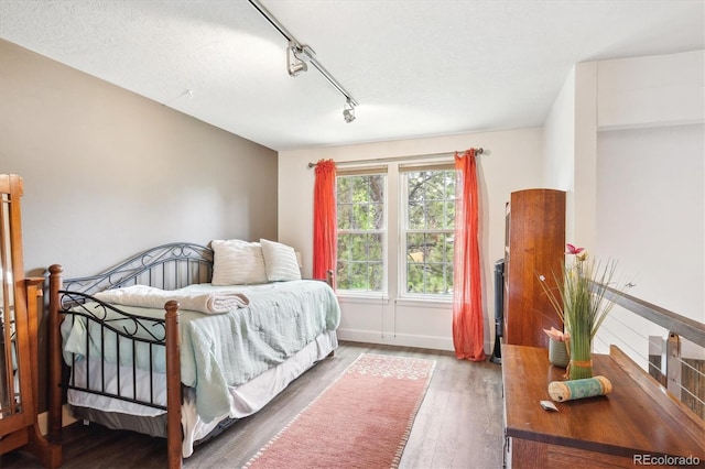 8170 E Phillips Cir, Centennial, CO 80112 - bedroom with rail lighting and wood finished floors