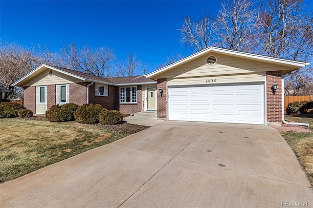 single story home with concrete driveway, an attached garage, fence, a front lawn, and brick siding