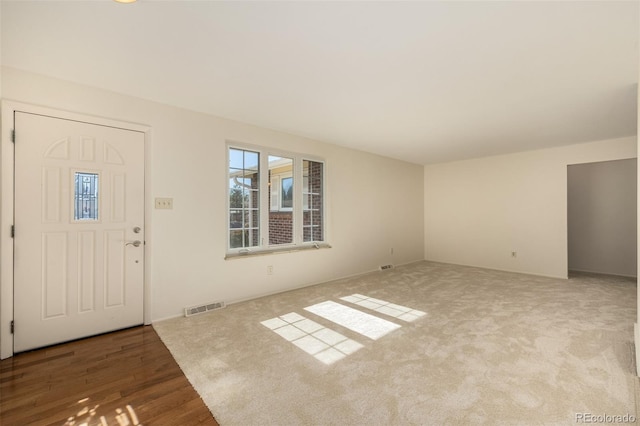 entrance foyer featuring visible vents and wood finished floors