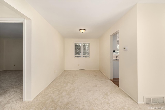 empty room featuring carpet and visible vents