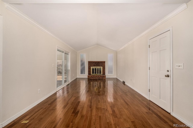 unfurnished living room featuring a brick fireplace, crown molding, and hardwood / wood-style floors