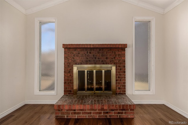 room details featuring ornamental molding, a brick fireplace, wood finished floors, and baseboards