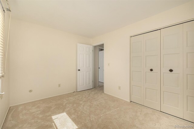 unfurnished bedroom featuring a closet and carpet