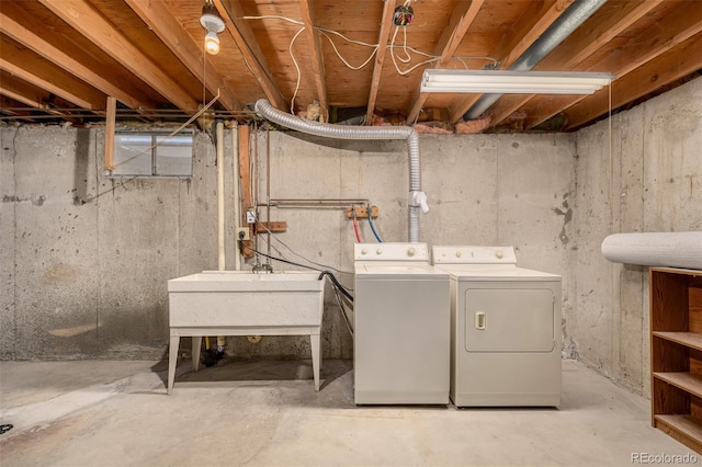 washroom with laundry area, independent washer and dryer, and a sink