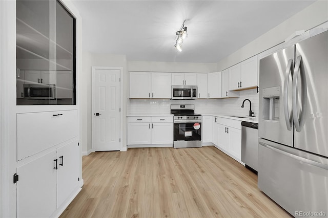 2503-2507 N Taft Ave, Loveland, CO 80538 - kitchen featuring stainless steel appliances, tasteful backsplash, light countertops, and white cabinets