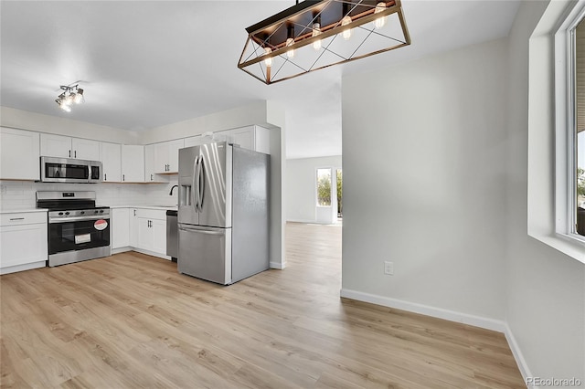 2503-2507 N Taft Ave, Loveland, CO 80538 - kitchen with stainless steel appliances, backsplash, light countertops, and light wood-style flooring