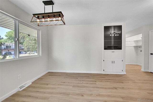 2503-2507 N Taft Ave, Loveland, CO 80538 - unfurnished dining area with light wood-style flooring and baseboards