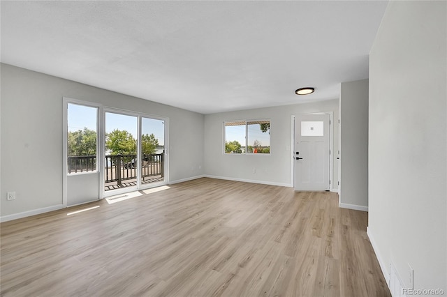 2503-2507 N Taft Ave, Loveland, CO 80538 - unfurnished living room featuring light wood-type flooring and baseboards