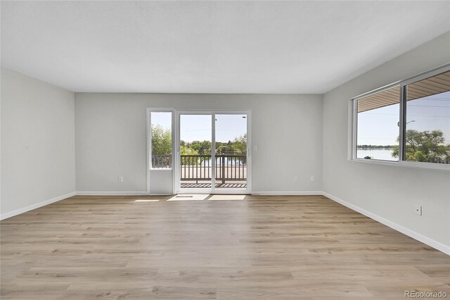 2503-2507 N Taft Ave, Loveland, CO 80538 - spare room with plenty of natural light, light wood-style flooring, and a water view