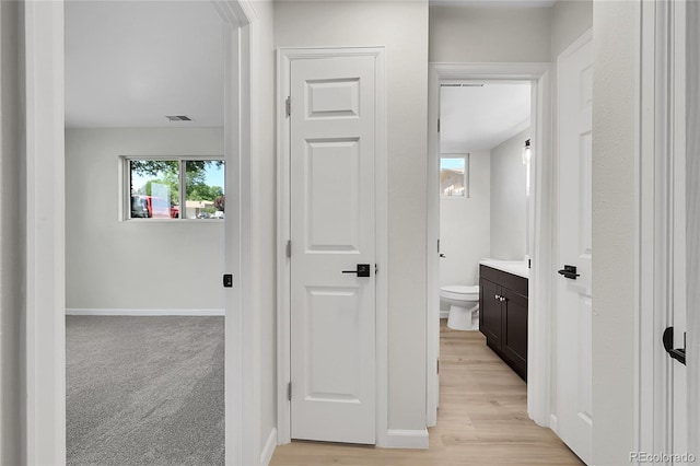 2503-2507 N Taft Ave, Loveland, CO 80538 - hallway featuring baseboards and light wood-style floors