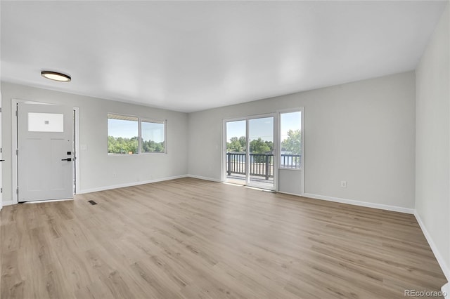 2503-2507 N Taft Ave, Loveland, CO 80538 - unfurnished living room featuring baseboards and light wood-style floors