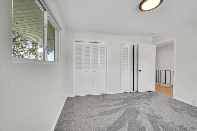 2503-2507 N Taft Ave, Loveland, CO 80538 - unfurnished bedroom with carpet floors and two closets