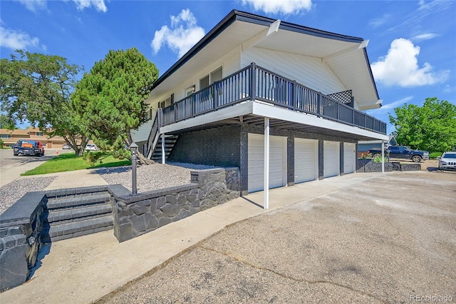 2503-2507 N Taft Ave, Loveland, CO 80538 - view of side of home featuring a garage, driveway, a wooden deck, and stairway