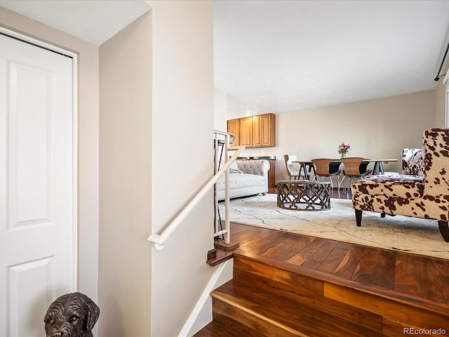 stairway featuring hardwood / wood-style floors and baseboards