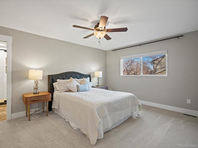 bedroom with baseboards, a ceiling fan, visible vents, and light colored carpet