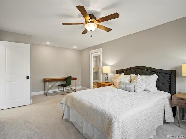 bedroom with recessed lighting, a spacious closet, a ceiling fan, light carpet, and baseboards