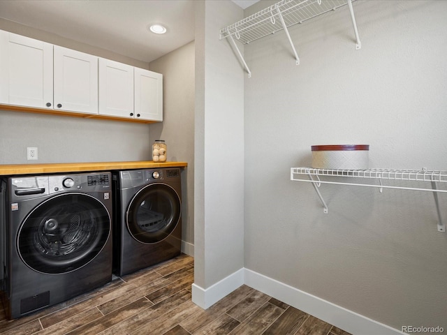 laundry room with recessed lighting, baseboards, washer and dryer, cabinet space, and wood tiled floor