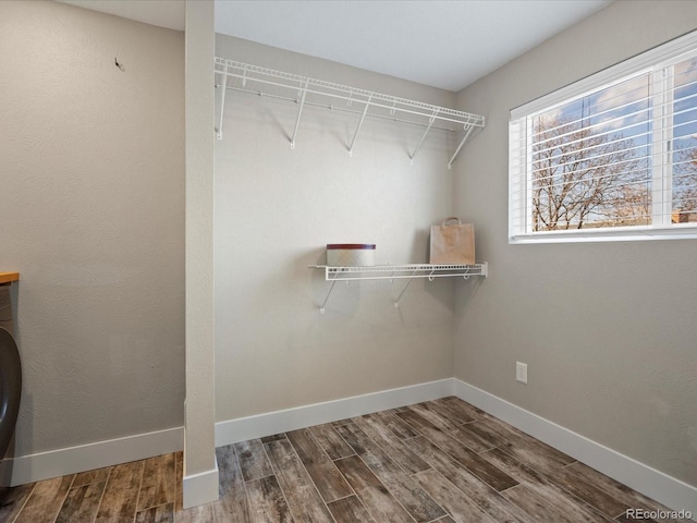 walk in closet featuring washer / dryer and wood finished floors