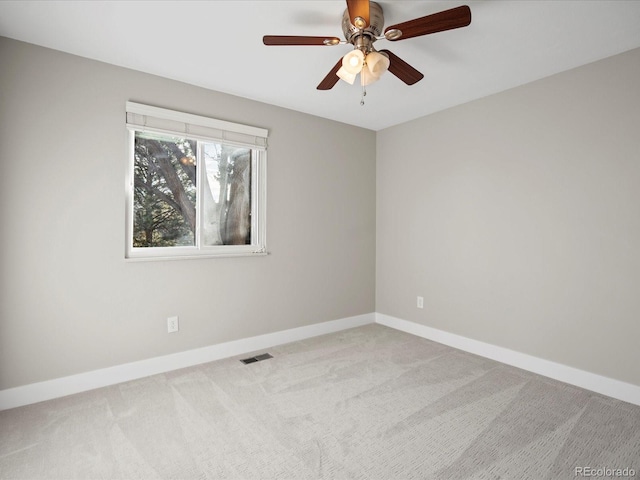 spare room featuring baseboards, visible vents, ceiling fan, and carpet flooring