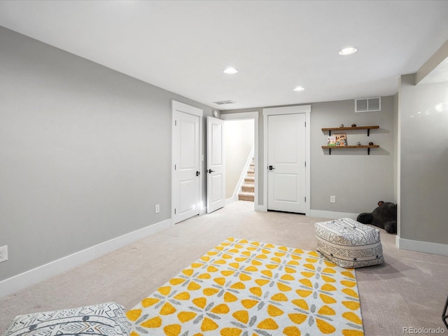 interior space featuring carpet floors, recessed lighting, visible vents, and baseboards