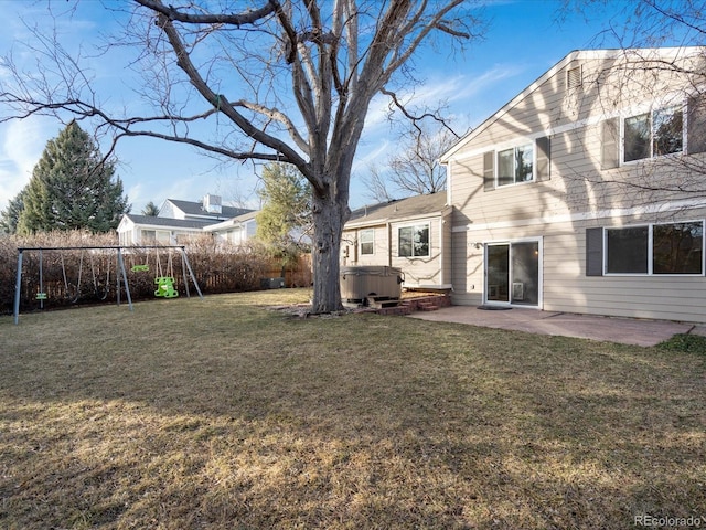 view of yard with a patio area, a playground, a hot tub, and fence