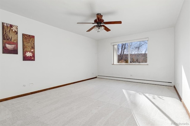 carpeted spare room featuring ceiling fan and a baseboard heating unit