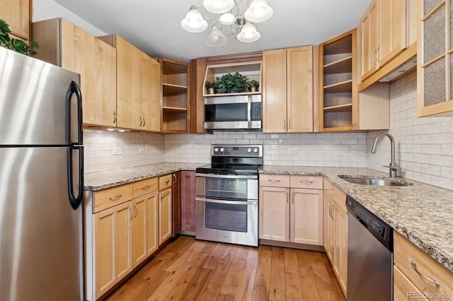kitchen featuring open shelves, a notable chandelier, appliances with stainless steel finishes, a sink, and light brown cabinets